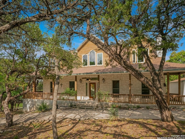 view of front of property with a porch and stone siding