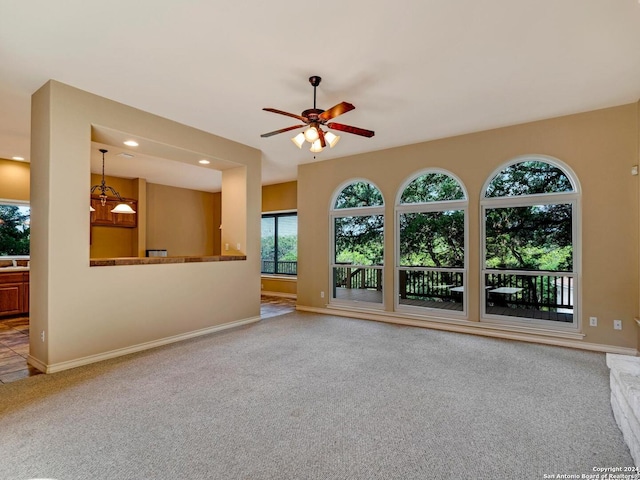 unfurnished living room with ceiling fan, baseboards, carpet flooring, and recessed lighting