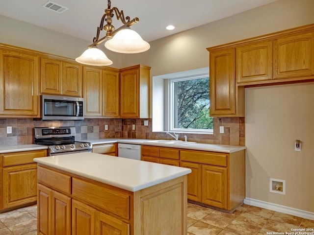 kitchen featuring backsplash, sink, pendant lighting, and appliances with stainless steel finishes