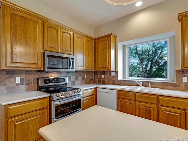 kitchen featuring sink, backsplash, and stainless steel appliances