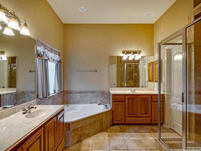 full bathroom with a stall shower, two vanities, a sink, and visible vents