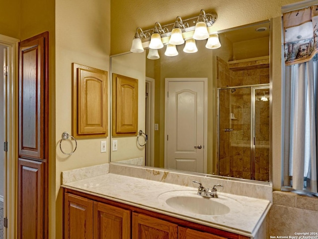 bathroom with an enclosed shower and vanity