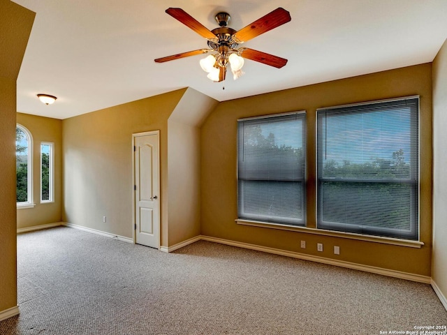 additional living space with light carpet, a ceiling fan, and baseboards