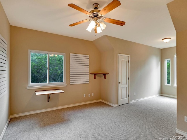 spare room with baseboards, a ceiling fan, and light colored carpet