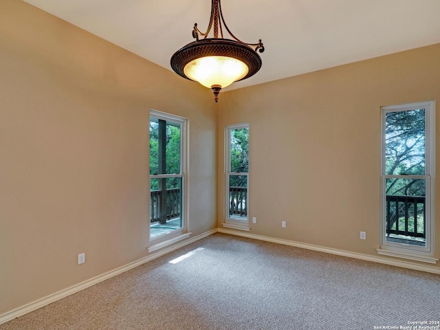 carpeted empty room with baseboards