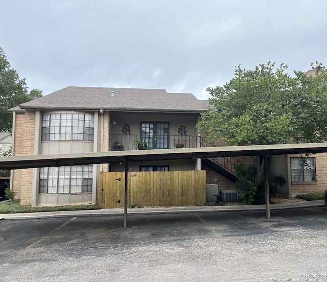 view of front of house with a carport and central AC