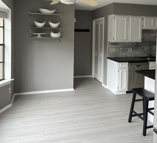 kitchen featuring decorative backsplash, dishwasher, a wealth of natural light, and ceiling fan