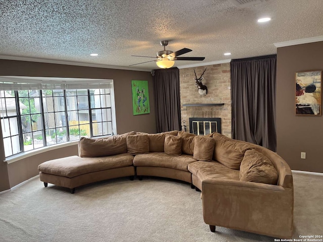 carpeted living room with ceiling fan, crown molding, a textured ceiling, and a brick fireplace