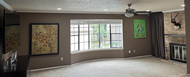 unfurnished living room with a fireplace, a textured ceiling, ceiling fan, and light colored carpet