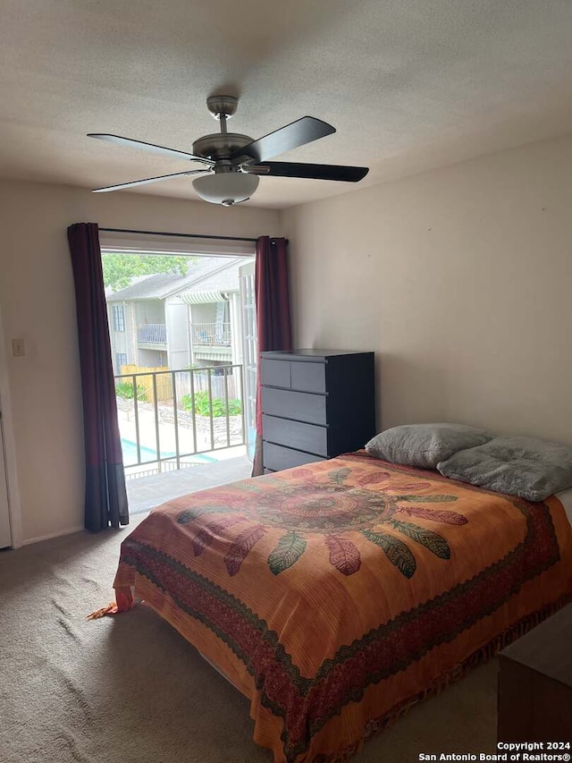 bedroom featuring light colored carpet, a textured ceiling, access to outside, and ceiling fan