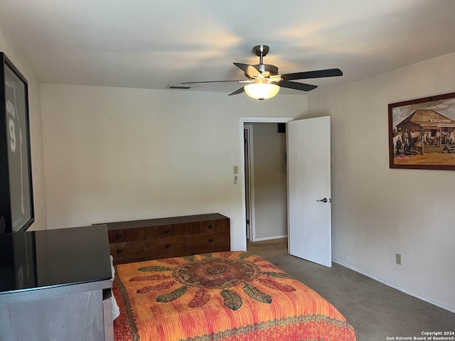 bedroom featuring ceiling fan and dark carpet