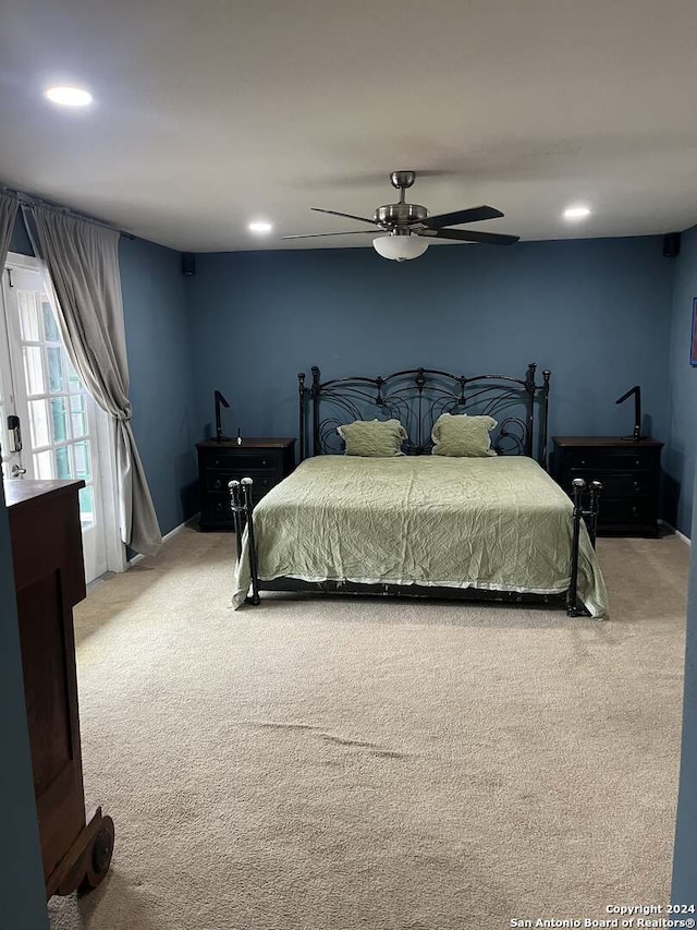 carpeted bedroom with ceiling fan