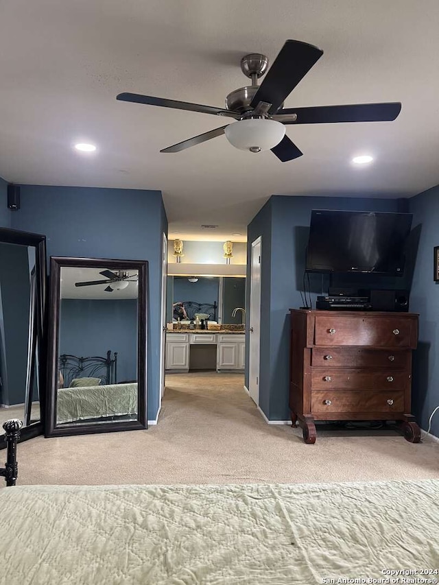 carpeted bedroom featuring sink and ceiling fan