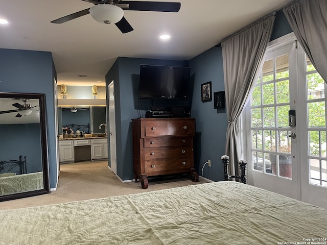 bedroom with light carpet, connected bathroom, and ceiling fan