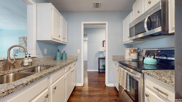 kitchen featuring white cabinetry, appliances with stainless steel finishes, sink, and light stone counters