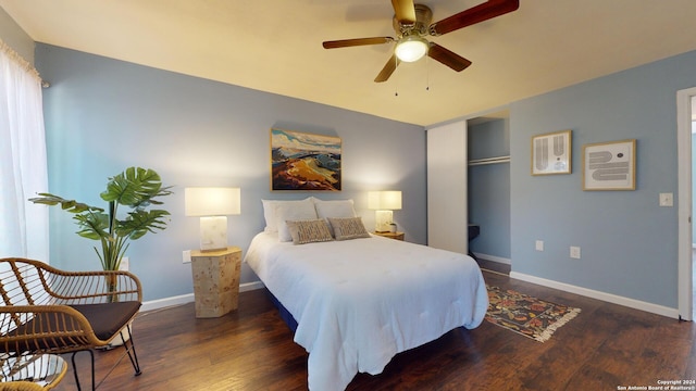 bedroom with dark wood-type flooring, ceiling fan, and a closet