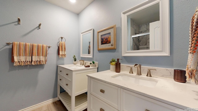 bathroom with a shower with door, vanity, and hardwood / wood-style floors