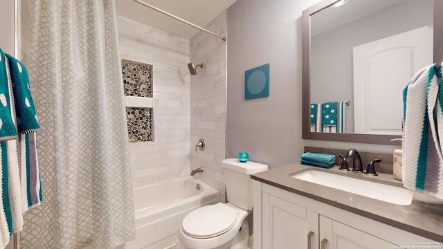 full bathroom with vanity, shower / bath combination with curtain, and toilet