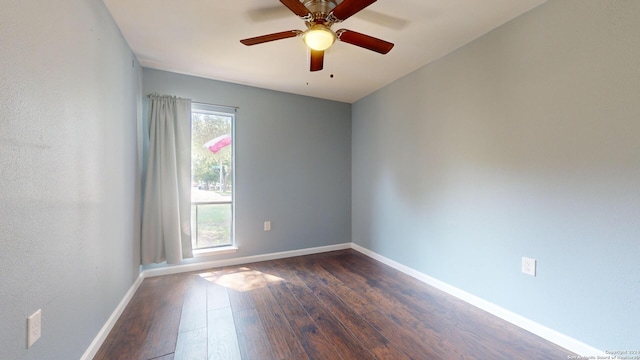 spare room featuring dark wood-type flooring and ceiling fan