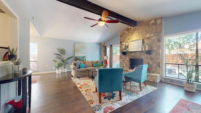 living room featuring dark wood-type flooring, a fireplace, lofted ceiling with beams, and ceiling fan