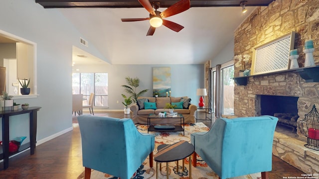 living room featuring a stone fireplace, dark wood-type flooring, lofted ceiling with beams, and ceiling fan