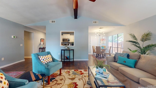 living room with vaulted ceiling with beams, dark wood-type flooring, and a notable chandelier