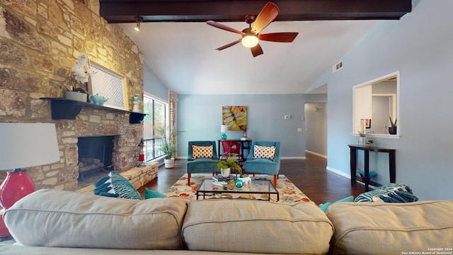 living room with dark wood-type flooring, ceiling fan, a fireplace, and vaulted ceiling with beams