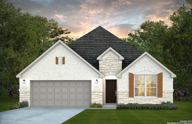 view of front facade with a garage and a lawn