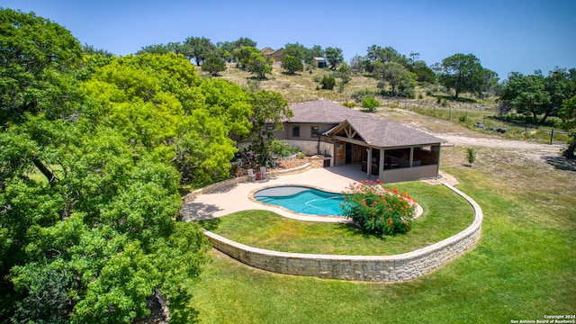 view of pool featuring a patio area and a yard