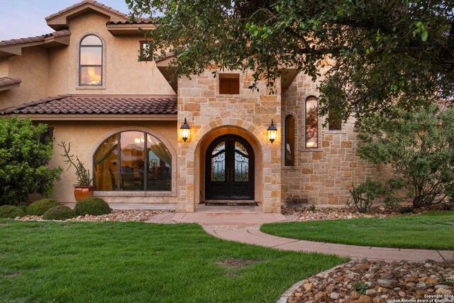 back house at dusk with a patio