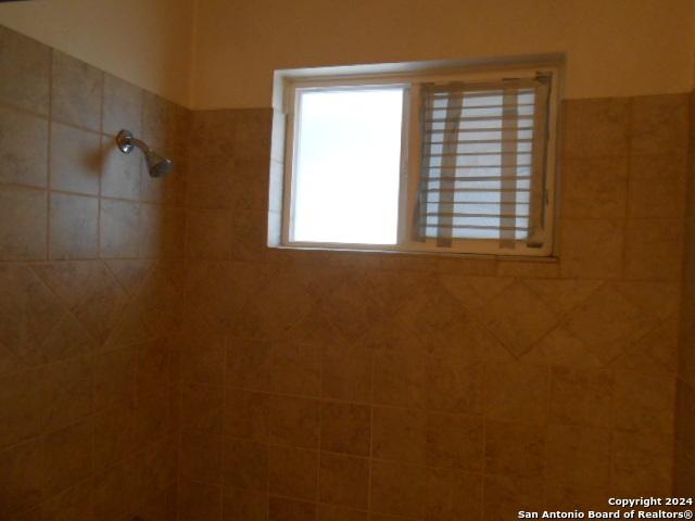 bathroom with a tile shower