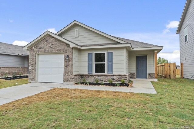 view of front facade with a garage and a front yard