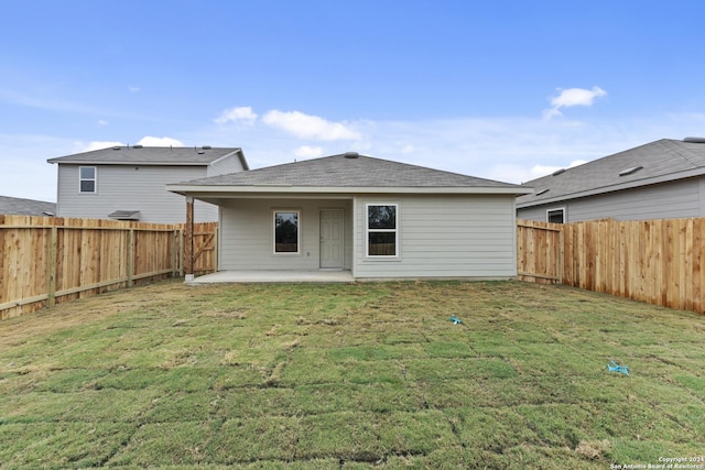 back of property featuring a yard and a patio area