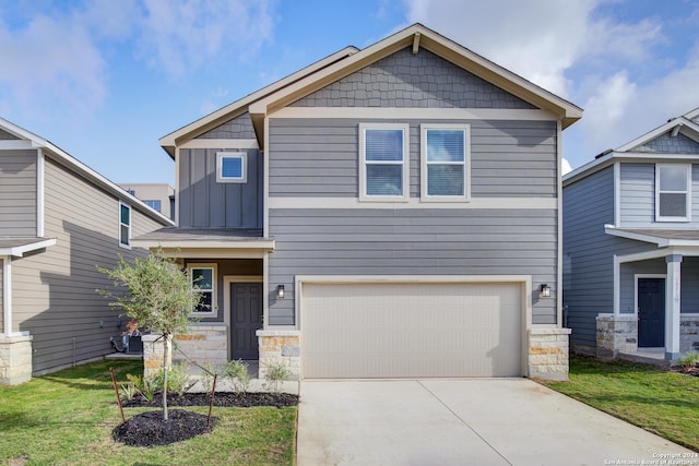 craftsman inspired home with a front yard and a garage