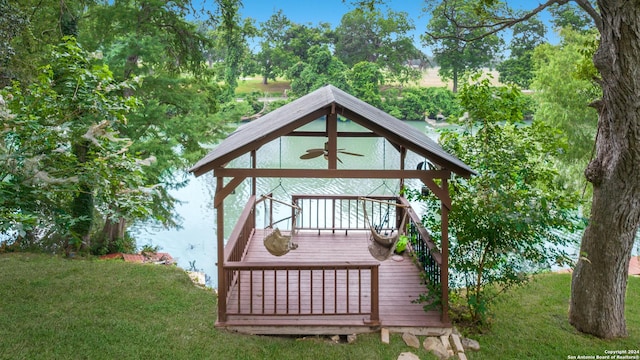 wooden deck featuring ceiling fan and a yard