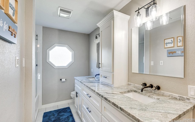 bathroom with vanity, tile patterned floors, and toilet