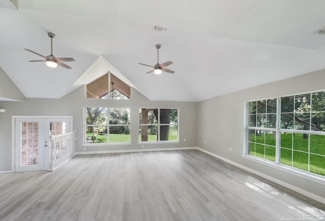 unfurnished living room with light hardwood / wood-style flooring, french doors, ceiling fan, and vaulted ceiling