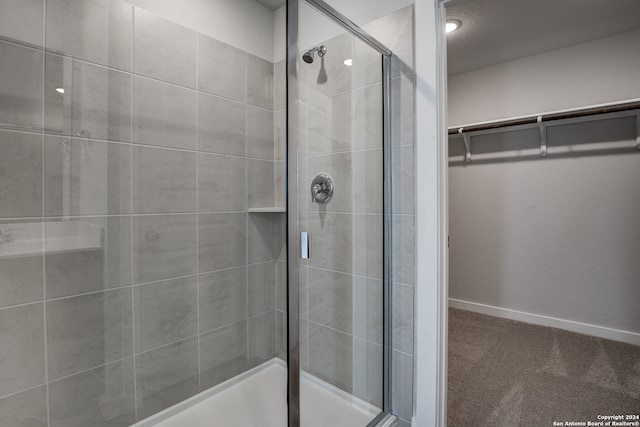 bathroom featuring a shower with door