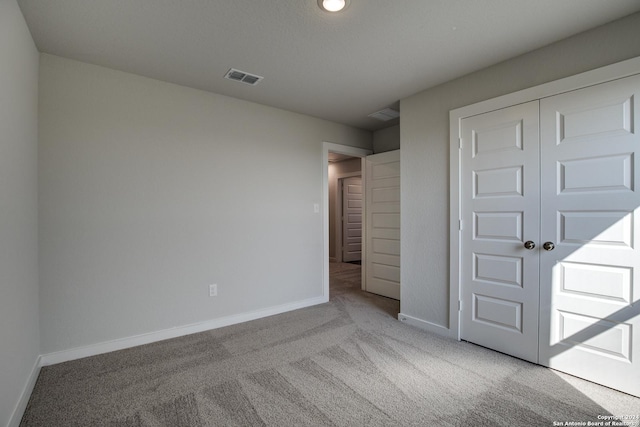 unfurnished bedroom with recessed lighting, carpet, visible vents, a closet, and baseboards
