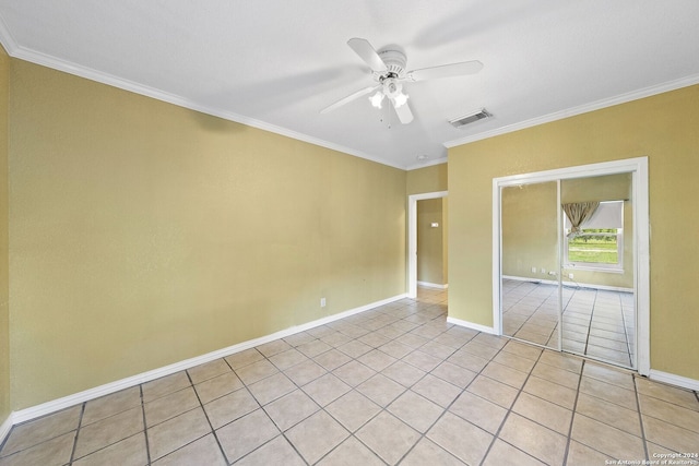 empty room featuring crown molding, ceiling fan, and light tile patterned flooring