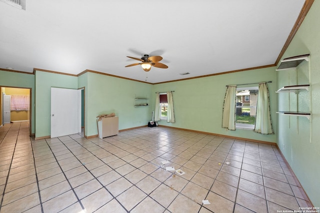 tiled spare room with ceiling fan, crown molding, and a healthy amount of sunlight