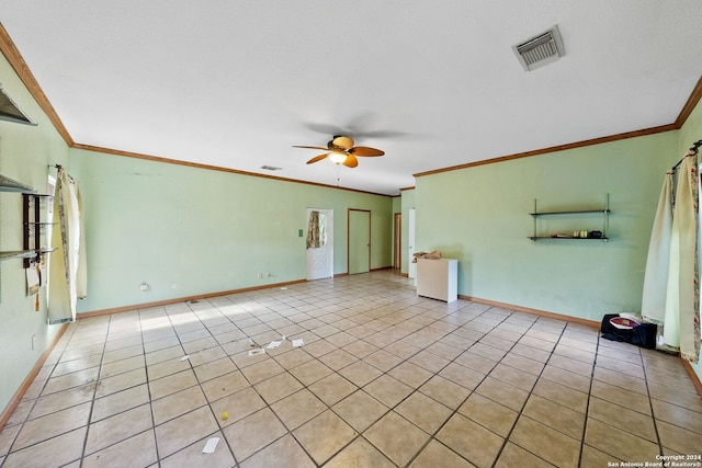 empty room with ceiling fan, light tile patterned floors, and crown molding