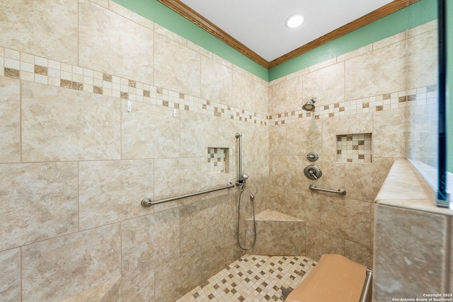 bathroom with crown molding and tiled shower