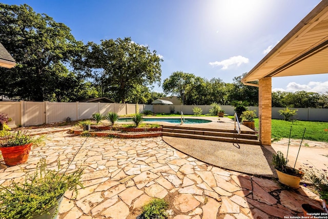 view of patio / terrace with a fenced in pool