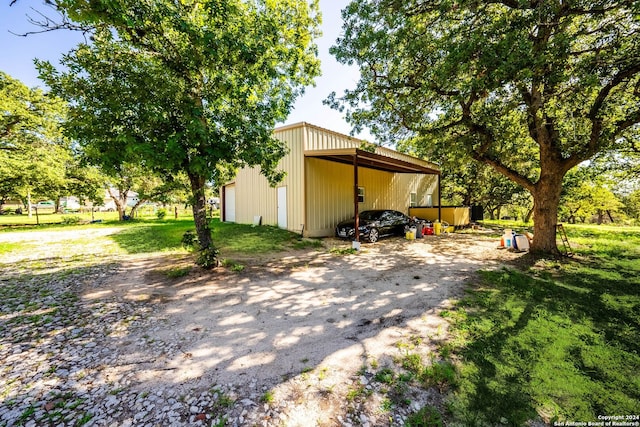 view of yard with an outdoor structure and a carport