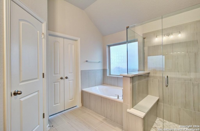 bathroom featuring tile patterned floors, lofted ceiling, and plus walk in shower