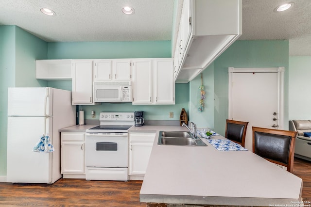 kitchen with white cabinetry, sink, white appliances, dark wood-type flooring, and a textured ceiling