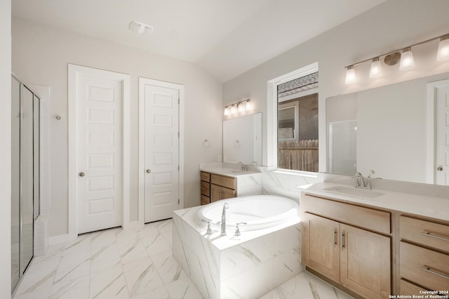 bathroom with vanity, independent shower and bath, and vaulted ceiling