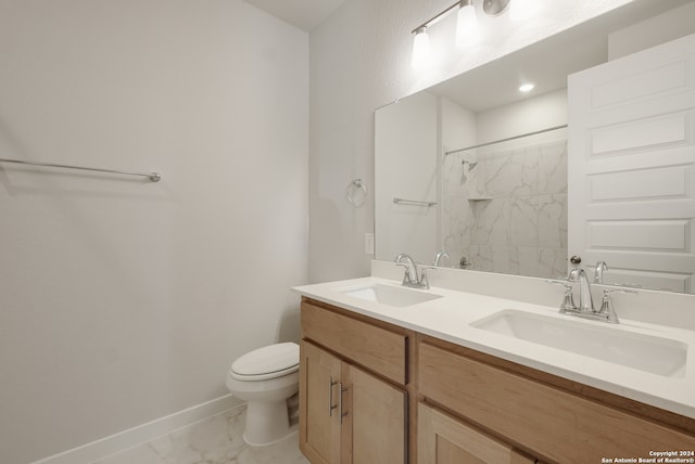 bathroom with toilet, vanity, and tiled shower