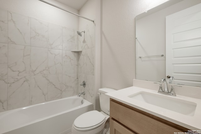 full bathroom featuring vanity, toilet, and tiled shower / bath combo